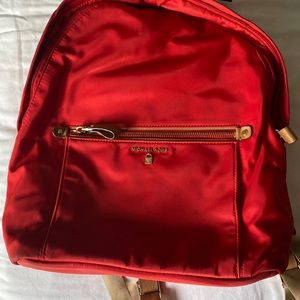 Red used Michael kors backpack in great condition